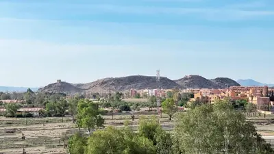 a view of a city with mountains in the background at Marrakech Station Apartment in Marrakech