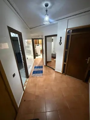 an empty hallway with a door and a tile floor at appartement Yasmine à Marrakech in Marrakech
