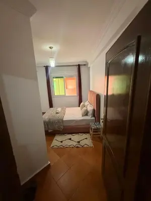 a small bedroom with a bed and a window at appartement Yasmine à Marrakech in Marrakech