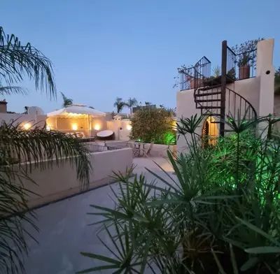 a house with a courtyard with plants in front of it at RIAD Azur in Marrakech