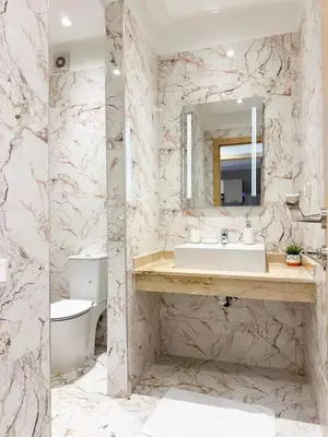 a bathroom with a sink and a toilet at Noraya Home - Secure residence with pool in Marrakech