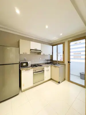 a kitchen with a stainless steel refrigerator and appliances at Noraya Home - Secure residence with pool in Marrakech