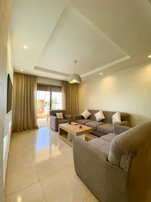 a living room with a couch and a table at Noraya Home - Secure residence with pool in Marrakech