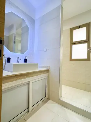a bathroom with a sink and a mirror at Noraya Home - Secure residence with pool in Marrakech