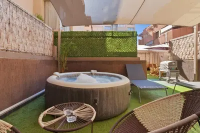 a hot tub on a patio with two chairs at T2 - Terrasse et Jacuzzi - Coeur de Guéliz in Marrakech
