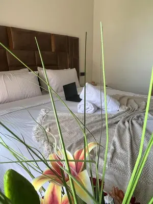 a bedroom with a bed with a laptop on it at Super 3-bedroom living room with view of Prestigia Golf Pools in Marrakech