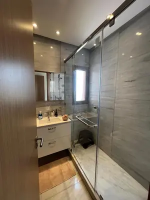 a bathroom with a shower and a sink at Super 3-bedroom living room with view of Prestigia Golf Pools in Marrakech