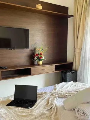 a laptop sitting on top of a bed with a tv at Super 3-bedroom living room with view of Prestigia Golf Pools in Marrakech