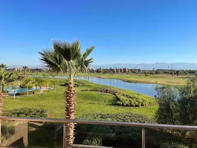 a palm tree in the middle of a river at Super 3-bedroom living room with view of Prestigia Golf Pools in Marrakech