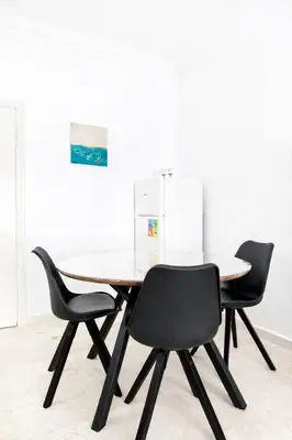 a dining table and chairs in a room at Residence Nadia in Marrakech