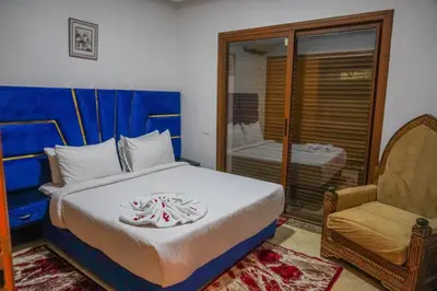 a bedroom with a bed and a chair at فيلال نادية in Marrakech