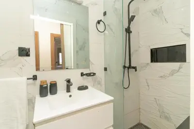 a bathroom with a sink and a shower at Elegant Modern Appartement in Gueliz Luxury Touch in Oulad Akkou