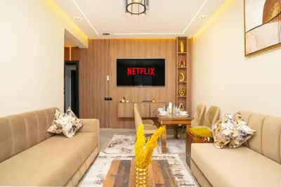 a living room with two couches and a tv at Elegant Modern Appartement in Gueliz Luxury Touch in Oulad Akkou