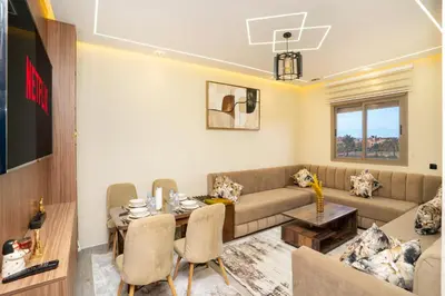 a living room with a couch and a table at Elegant Modern Appartement in Gueliz Luxury Touch in Oulad Akkou