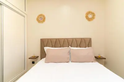 a bedroom with a white bed with two pillows at Elegant Modern Appartement in Gueliz Luxury Touch in Oulad Akkou