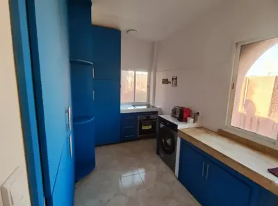 a kitchen with blue cabinets and a sink at Cocon calme et confortable wifi Netflix Gueliz Daoudiate in Marrakech