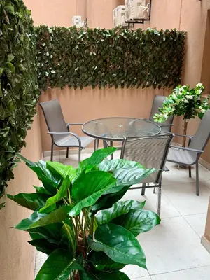 a patio with chairs and a table and plants at Luxury Town Center Gueliz 2 Chambres Parking Grande Terrasse in Marrakech