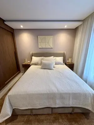 a bedroom with a large white bed with two night stands at Luxury Town Center Gueliz 2 Chambres Parking Grande Terrasse in Marrakech