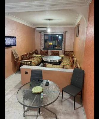 a living room with a table and a couch at Boston in Marrakech
