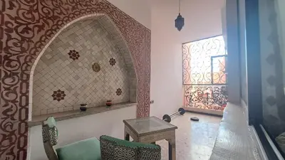 a room with a chair and a table and a window at Chez Abdou II in Marrakech