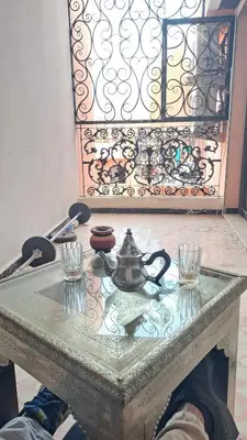 a table with a tea kettle and glasses on it at Chez Abdou II in Marrakech