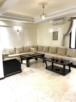 a living room with a couch and two tables at Chez Abdou II in Marrakech
