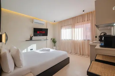 a hotel room with a bed and a tv at Studio elegant raffine pour un sejour tout confort in Marrakech
