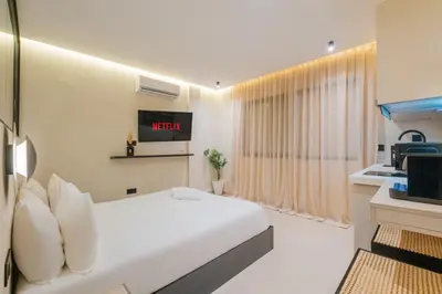 a hotel room with a bed and a tv at Studio elegant raffine pour un sejour tout confort in Marrakech