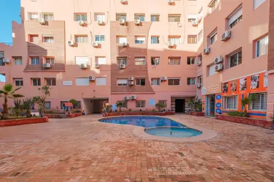 a courtyard with a pool in front of a building at Studio elegant raffine pour un sejour tout confort in Marrakech