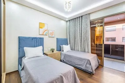 a hotel room with two beds and a tv at Luxury 2-bedroom apartment in Marrakech
