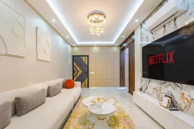 a living room with a couch and a tv at Luxury 2-bedroom apartment in Marrakech