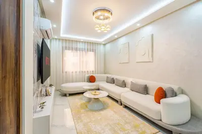 a living room with a couch and a table at Luxury 2-bedroom apartment in Marrakech