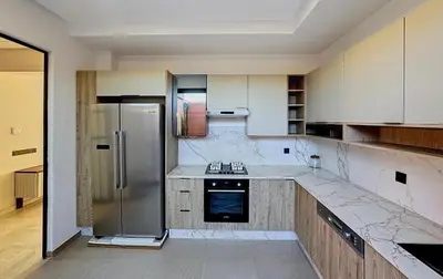 a large kitchen with a refrigerator and a stove at Abwab in Marrakech