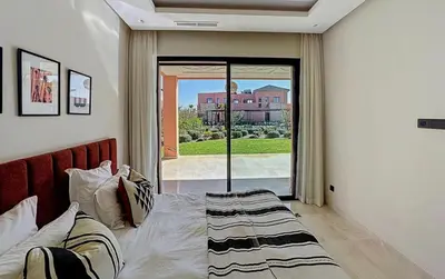 a bedroom with a bed and a large window at Abwab in Marrakech