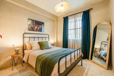 a bedroom with a bed and a large window at Beautiful Moroccan 2BR Close to City Center in Marrakech