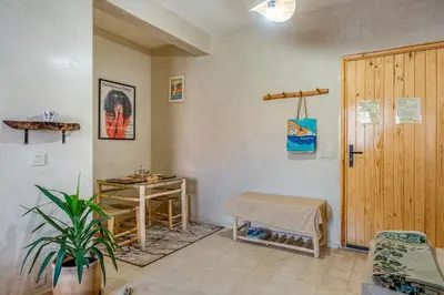 a waiting room with a table and a wooden door at Beautiful Moroccan 2BR Close to City Center in Marrakech