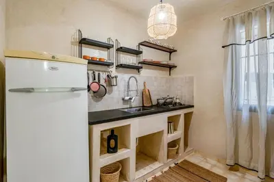 a kitchen with a sink and a refrigerator at Beautiful Moroccan 2BR Close to City Center in Marrakech