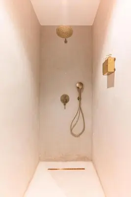 a shower with a shower head in a room at Suite Afra - Cinéma privé & Central in Marrakech