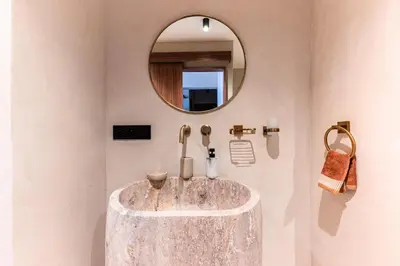 a bathroom with a marble sink and a mirror at Suite Afra - Cinéma privé & Central in Marrakech