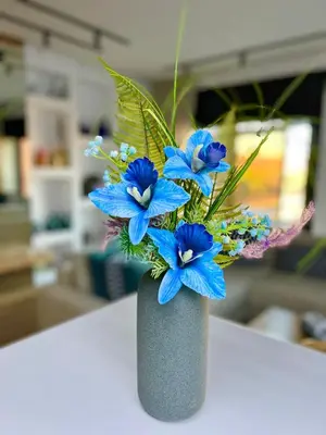 a vase filled with blue flowers on a table at Appartement Marrakech Hivernage N28 RÉSIDENCE CAPRICE PALACE in Marrakech