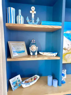 a blue room with wooden shelves with toys on them at Appartement Marrakech Hivernage N28 RÉSIDENCE CAPRICE PALACE in Marrakech