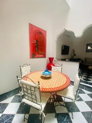 a dining room with a table and chairs at Havre de Paix in Marrakech