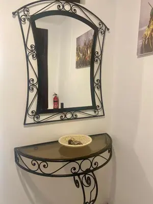 a mirror on top of a shelf with a sink at Havre de Paix in Marrakech