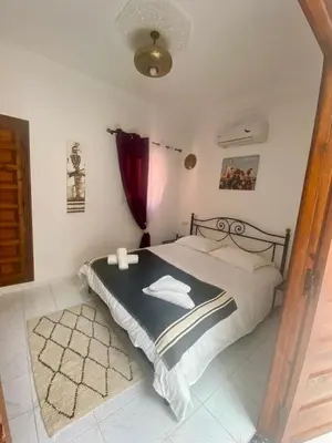 a bedroom with a bed and a red curtain at Havre de Paix in Marrakech