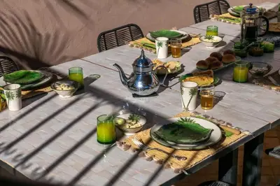 a table with plates of food on top of it at Riad Dar Khadra Heritage - Piscine chauffée et Rooftop au cœur de la médina in Marrakech
