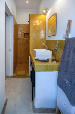 a bathroom with a sink and a shower at Riad Dar Khadra Heritage - Piscine chauffée et Rooftop au cœur de la médina in Marrakech
