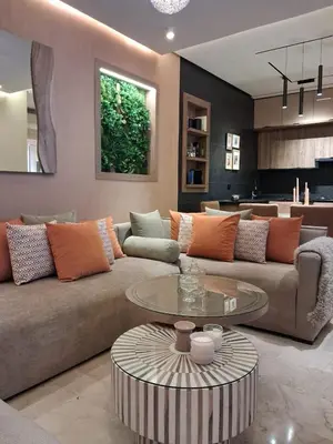 a living room with a couch and a table at Prestigia Agathe in Marrakech