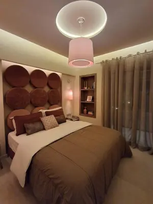a bedroom with a large bed with a large headboard at Prestigia Agathe in Marrakech