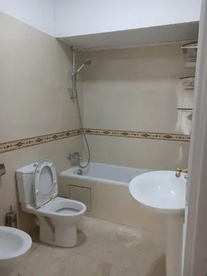 a bathroom with a toilet and a sink at Appartement familial - 2 chambres - Hivernage in Marrakech