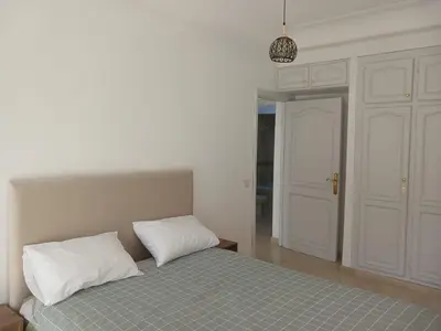 a bedroom with a bed with two pillows on it at Appartement familial - 2 chambres - Hivernage in Marrakech